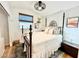 Cozy bedroom showcasing a wrought iron bed frame, soft bedding and unique decor accents at 8233 Hydra Ln, Las Vegas, NV 89128