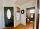 Inviting entryway with a black front door, wood-look floors, and access to a half bath at 8233 Hydra Ln, Las Vegas, NV 89128