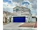 Attractive two-story house with a vibrant blue garage door, enhanced by neat landscaping and a welcoming driveway at 8233 Hydra Ln, Las Vegas, NV 89128