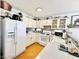 Well-lit kitchen with white cabinets, modern appliances, and a mosaic backsplash, creating a clean and functional space at 8233 Hydra Ln, Las Vegas, NV 89128