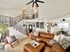 Spacious living room with vaulted ceilings, a cozy leather sofa, and stylish decor, creating an inviting atmosphere at 8233 Hydra Ln, Las Vegas, NV 89128
