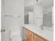 Bathroom features a vanity with sink, toilet, and a shower behind a glass door at 8426 Sluman Ct, Las Vegas, NV 89128