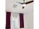 Bedroom features a modern ceiling fan, large window with curtains, and ample natural light at 8426 Sluman Ct, Las Vegas, NV 89128