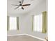 Bedroom features ceiling fan, large windows with curtains, and ample natural light at 8426 Sluman Ct, Las Vegas, NV 89128