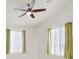 Bedroom features ceiling fan, large windows with curtains, and ample natural light at 8426 Sluman Ct, Las Vegas, NV 89128