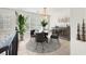 Bright dining room featuring a round table, four chairs, elegant decor, and natural light streaming through large windows at 8426 Sluman Ct, Las Vegas, NV 89128