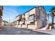 Multi-story condominium complex with garages and mature palm trees at 8426 Sluman Ct, Las Vegas, NV 89128