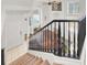 Bright foyer with stairs, black railing, and tiled floors, offering a welcoming entrance at 8426 Sluman Ct, Las Vegas, NV 89128