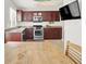 Open kitchen features dark cabinets, stainless steel appliances, granite countertops, and tile flooring at 8426 Sluman Ct, Las Vegas, NV 89128