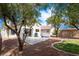 Charming backyard features a patio with a grill, surrounded by mature trees and well-kept landscaping at 8582 Manalang Rd, Las Vegas, NV 89123