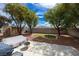 Spacious backyard featuring a patio, small lawn, mature trees, shed, and a block wall, providing a serene outdoor space at 8582 Manalang Rd, Las Vegas, NV 89123
