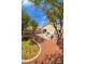 Spacious backyard features a patio with grill, mature trees, and well-maintained landscaping at 8582 Manalang Rd, Las Vegas, NV 89123