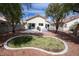 A spacious backyard offers a patio, lawn bordered with stone, mature trees, and a clean, well-maintained space at 8582 Manalang Rd, Las Vegas, NV 89123