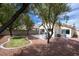 Lovely backyard offers a patio with a grill, shade trees, and easy-care landscaping at 8582 Manalang Rd, Las Vegas, NV 89123