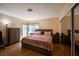 Cozy bedroom with wood floors, a window and mirror closet, and comfortable furniture at 8582 Manalang Rd, Las Vegas, NV 89123