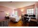 Charming bedroom with a bed, desk, and two windows offering ample natural light and a view to the outside at 8582 Manalang Rd, Las Vegas, NV 89123