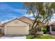 Inviting exterior view with a terracotta-tiled roof, well-manicured lawn, and an attached two-car garage at 8582 Manalang Rd, Las Vegas, NV 89123