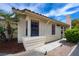 Exterior side view showcasing manicured shrubs and a tiled roof, providing charming curb appeal at 8582 Manalang Rd, Las Vegas, NV 89123