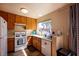 Bright kitchen featuring oak cabinetry, modern appliances, and a window offering views of the neighborhood at 8582 Manalang Rd, Las Vegas, NV 89123
