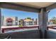 Balcony view of neighborhood buildings with red trim and parking spaces in front at 8600 W Charleston Blvd # 2190, Las Vegas, NV 89117