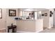 Bright kitchen featuring white appliances and cabinets with a breakfast bar overlooking the living area at 8600 W Charleston Blvd # 2190, Las Vegas, NV 89117