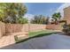 Private backyard featuring artificial turf, a sand box, and mature trees for shade at 8980 High Horizon Ave, Las Vegas, NV 89149