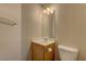 Small powder bathroom with vanity, toilet, and mirror at 8980 High Horizon Ave, Las Vegas, NV 89149
