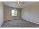 Bedroom with a ceiling fan and a window providing natural light and neighborhood views at 8980 High Horizon Ave, Las Vegas, NV 89149