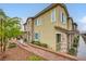 Charming townhome showcasing stone accents, a tiled roof, and verdant landscaping at 965 Nevada State Dr # 8202, Henderson, NV 89002