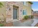Inviting townhome featuring a stone facade and a well-manicured lawn at 965 Nevada State Dr # 8202, Henderson, NV 89002