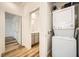 A well-lit laundry area with modern washer and dryer combo and wood floors at 965 Nevada State Dr # 8202, Henderson, NV 89002