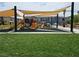 View of playground with play structures including slides under large shade covers at 965 Nevada State Dr # 8202, Henderson, NV 89002