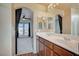 Bathroom featuring a double sink vanity, large mirror, and view to bedroom at 971 Sable Chase Pl, Henderson, NV 89011