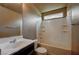 This well-lit bathroom includes a tub, toilet, and a sink with a dark brown vanity at 971 Sable Chase Pl, Henderson, NV 89011
