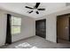 This bedroom has gray carpet, black trim, a ceiling fan, and a window at 971 Sable Chase Pl, Henderson, NV 89011