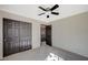 This bedroom has gray carpet, black trim, a ceiling fan, and a closet at 971 Sable Chase Pl, Henderson, NV 89011
