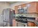 Kitchen featuring a stainless steel refrigerator and oven with granite countertops at 971 Sable Chase Pl, Henderson, NV 89011