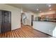 Open-concept living area boasts wood floors, stainless steel appliances, and access to the staircase at 971 Sable Chase Pl, Henderson, NV 89011