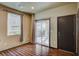 Bright living area with wood floors, a sliding door, and a convenient side door at 971 Sable Chase Pl, Henderson, NV 89011