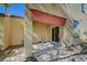 This patio has a stone base, a pillar, a sliding glass door, and a red awning at 971 Sable Chase Pl, Henderson, NV 89011
