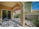 This patio has a stone base, a pillar, a sliding glass door, and some greenery at 971 Sable Chase Pl, Henderson, NV 89011