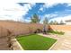 Backyard featuring manicured artificial lawns, patio, and desert landscaping at 9993 Skye Gazer Ave, Las Vegas, NV 89166