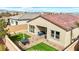 An aerial view of the cozy backyard featuring artificial turf, a patio set, and covered seating at 9993 Skye Gazer Ave, Las Vegas, NV 89166