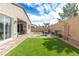 Enclosed backyard featuring patio, outdoor seating, and manicured artifical lawns at 9993 Skye Gazer Ave, Las Vegas, NV 89166