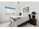 Bright bedroom featuring a plush bed, stylish side tables, and large window view at 9993 Skye Gazer Ave, Las Vegas, NV 89166