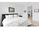 Bright bedroom featuring a queen bed with white linens and ensuite bathroom access at 9993 Skye Gazer Ave, Las Vegas, NV 89166
