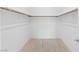 Empty walk-in closet with wood shelving and tile floors at 9993 Skye Gazer Ave, Las Vegas, NV 89166