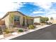 A street view of the single story home, showcasing desert landscaping and brick driveway at 9993 Skye Gazer Ave, Las Vegas, NV 89166