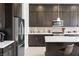 Kitchen features stainless steel appliances and dark wood cabinets at 9993 Skye Gazer Ave, Las Vegas, NV 89166