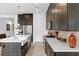Well-lit kitchen with white countertops, dark cabinets, and stainless-steel appliances at 9993 Skye Gazer Ave, Las Vegas, NV 89166
